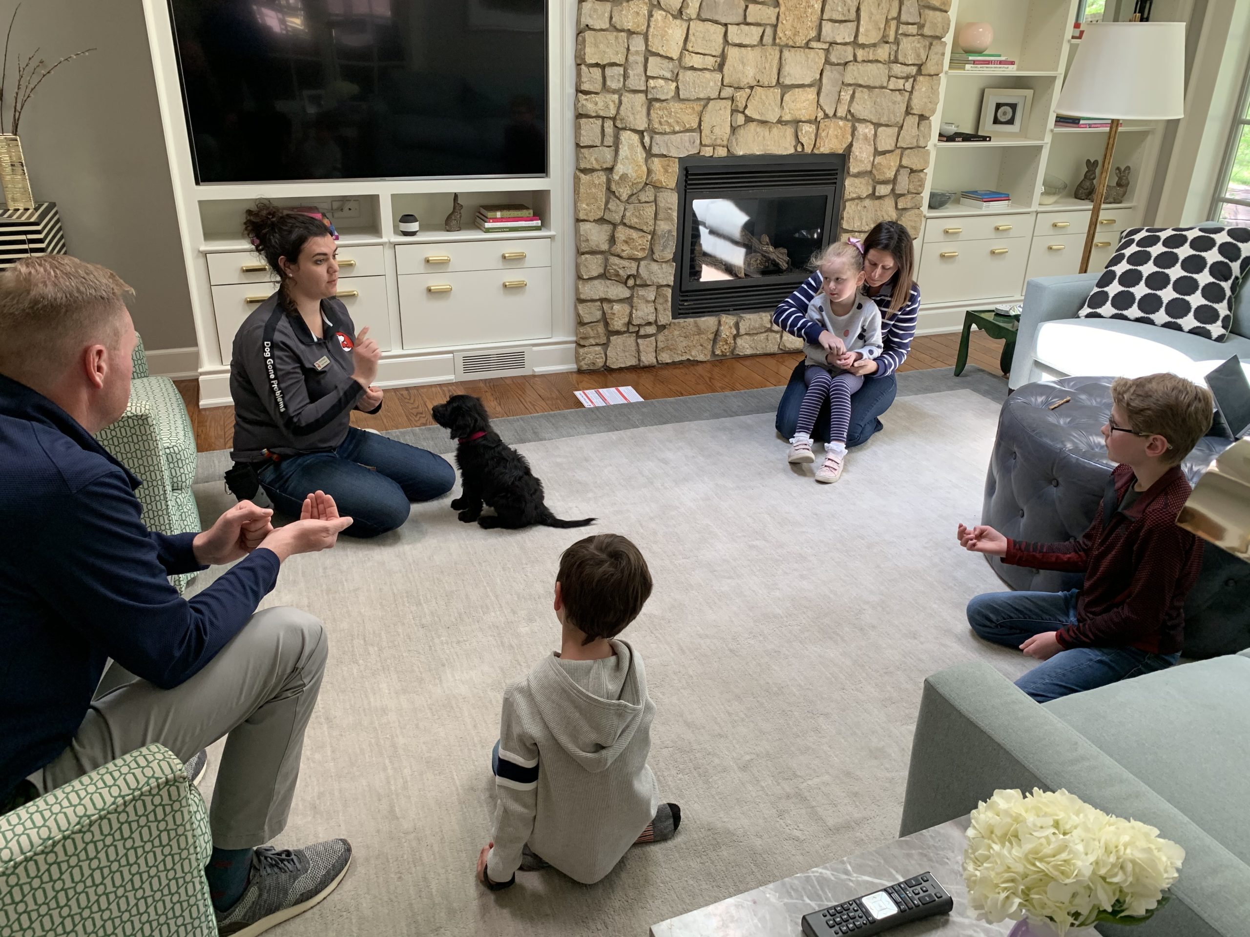 Dominique Trains Black Pup family scaled - In Home Omaha Dog Training